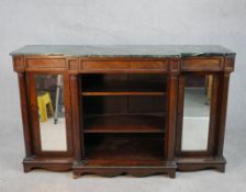 A William IV walnut breakfront sideboard, with a green marble top supported by four columns, with