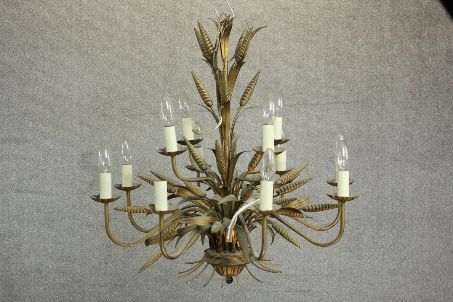 A Maison Jansen style brass and toleware chandelier, of wheatsheaf form, with twelve branches over