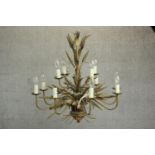A Maison Jansen style brass and toleware chandelier, of wheatsheaf form, with twelve branches over