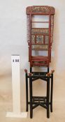 A late Qing Dynasty Chinese red and black lacquered washstand, the upper section with an array of