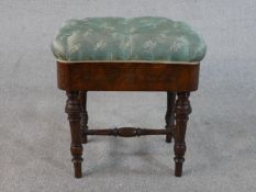 A Victorian James Shoolbred figured walnut piano stool, the buttoned seat upholstered in blue