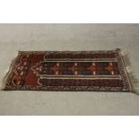 A hand made black ground Belouch rug. L.140 W.75cm.