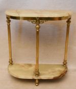 A circa 1970s brass and onyx console table of demi lune form, the onyx top and undertier with a