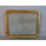 A 19th century gilt framed mirror, of rectangular form with rounded corners. H.77 W.93cm