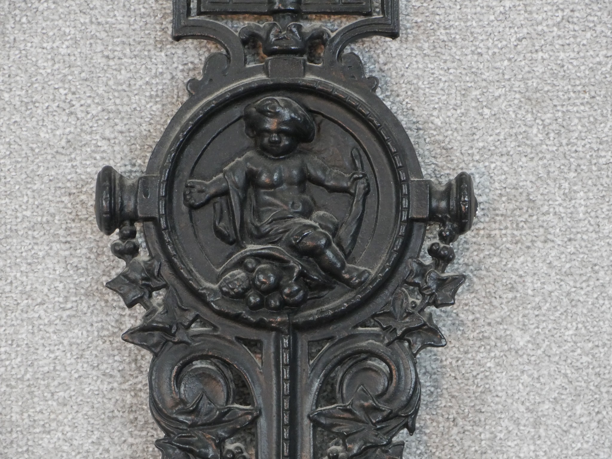A Victorian black painted cast iron umbrella stand, in four parts, the back cast with a cherub - Image 3 of 6