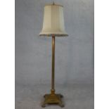 A Victorian brass fluted column design floor lamp with square base on four lion paw feet. H.170 W.38