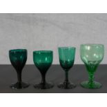 Three Victorian Bristol green wine glasses along with a 19th century pale green petal faceted glass.