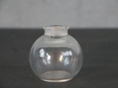 A Lalique perfume bottle, signed to base. (stopper missing) H.6cm