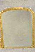 A Victorian gilt framed overmantel mirror, with a bevelled mirror plate, the frame with beaded and
