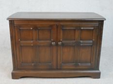 A mid century oak Ercol sideboard in the country antique style. H.70 W.103 D.50cm