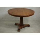 A mid 19th century walnut tilt top table, the circular top with a moulded edge, on a chamfered