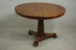 A mid 19th century walnut tilt top table, the circular top with a moulded edge, on a chamfered