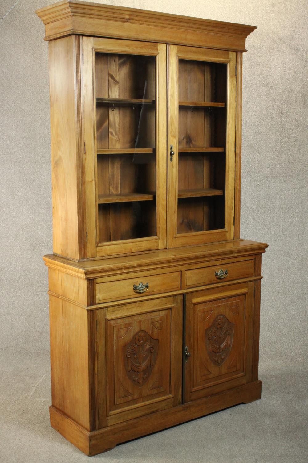 A Victorian style walnut bookcase, the two glazed doors enclosing shelves, over two short drawers - Image 9 of 11