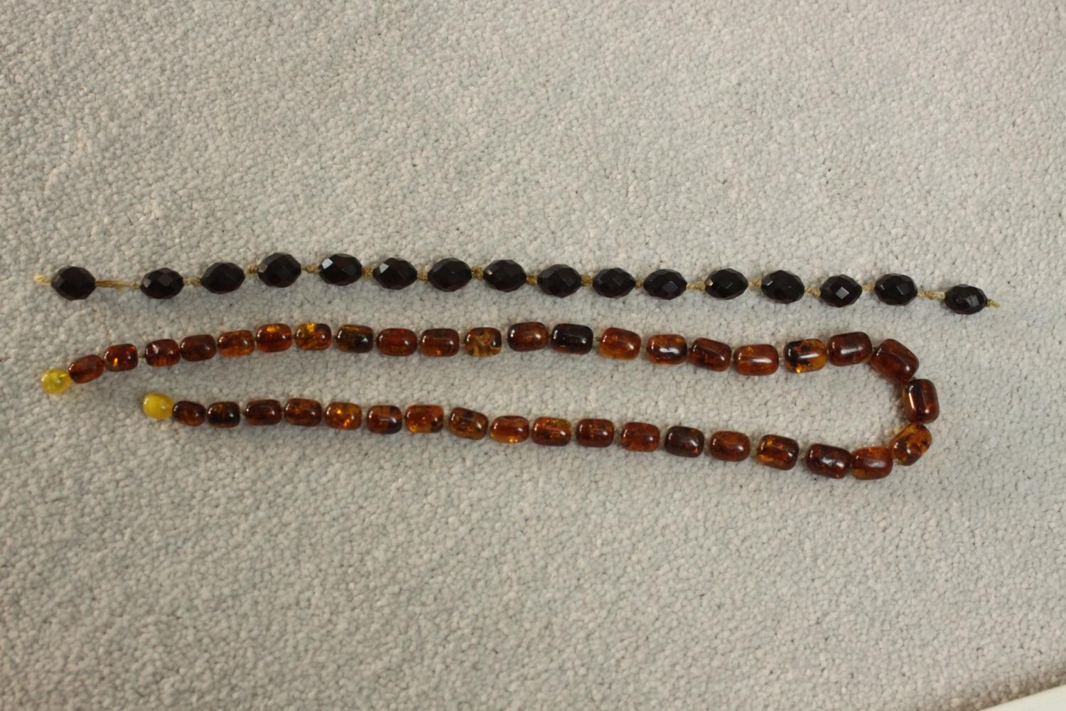 A vintage graduated Baltic amber bead necklace with a screw barrel clasp (damaged) along with a