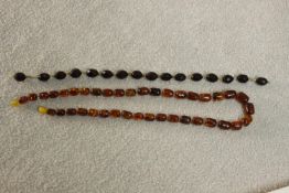 A vintage graduated Baltic amber bead necklace with a screw barrel clasp (damaged) along with a