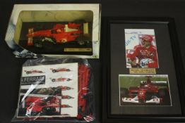 A framed and glazed photo of Michael Schumacher and his card, signed along with other Ferrari