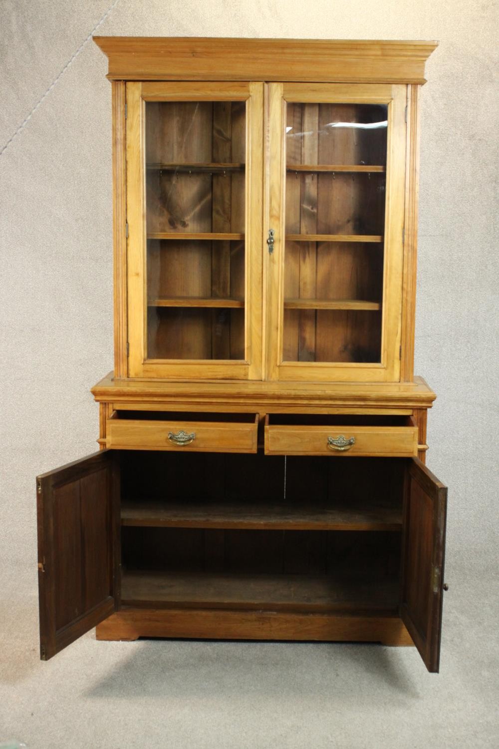 A Victorian style walnut bookcase, the two glazed doors enclosing shelves, over two short drawers - Image 5 of 11