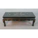 A Chinese lacquered coffee table with all over hand painted decoration. With plate glass top. H.47