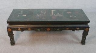 A Chinese lacquered coffee table with all over hand painted decoration. With plate glass top. H.47