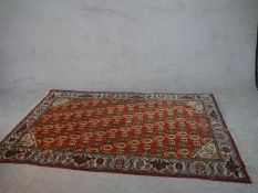 A red ground hand made Persian Ardebil carpet. L.230 W.148cm