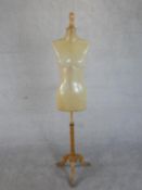 A fibre glass shop mannequin on a pine tripod base. H.173cm