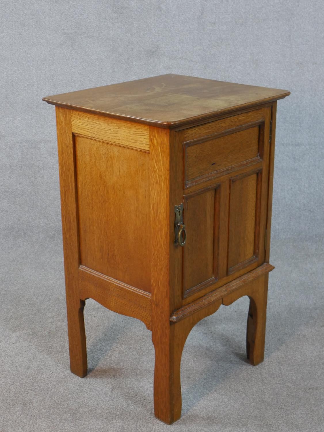 An Arts and Crafts oak bedside cabinet with panel door on shaped supports. H.73 W.45 D.39cm - Image 4 of 5