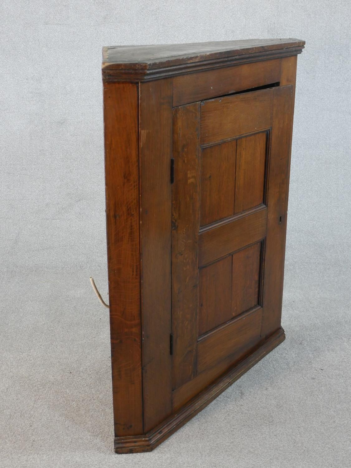 A 19th century oak hanging corner cabinet with panel door enclosing two shelves. H.106 W.94.5 W.46cm - Image 3 of 5