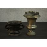 A 17th century cast iron mortar, with ribbed decoration, a flared rim and two handles, together with