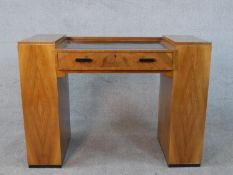 An Art Deco quarter veneered walnut desk with open bookshelves to each pedestal by Maple and Co. H.