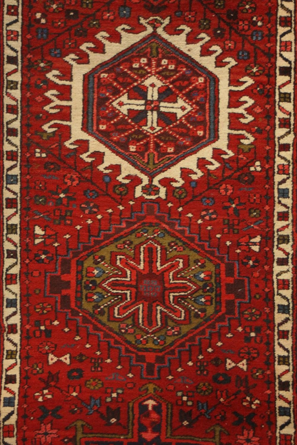 A hand made red ground Persian Heriz runner. L.440 W.100cm. - Image 4 of 5