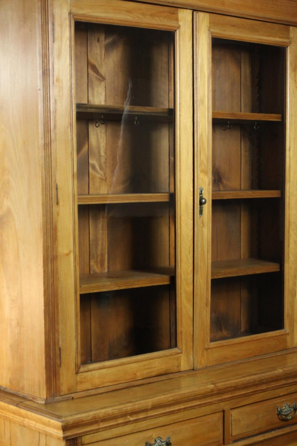 A Victorian style walnut bookcase, the two glazed doors enclosing shelves, over two short drawers - Image 10 of 11