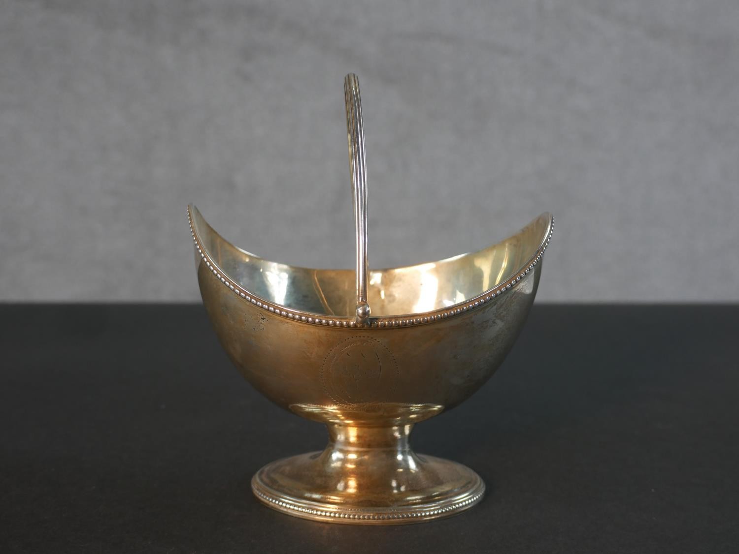 A Georgian sterling silver boat shaped sugar basket with handle and engraved cartouche along with - Image 4 of 6