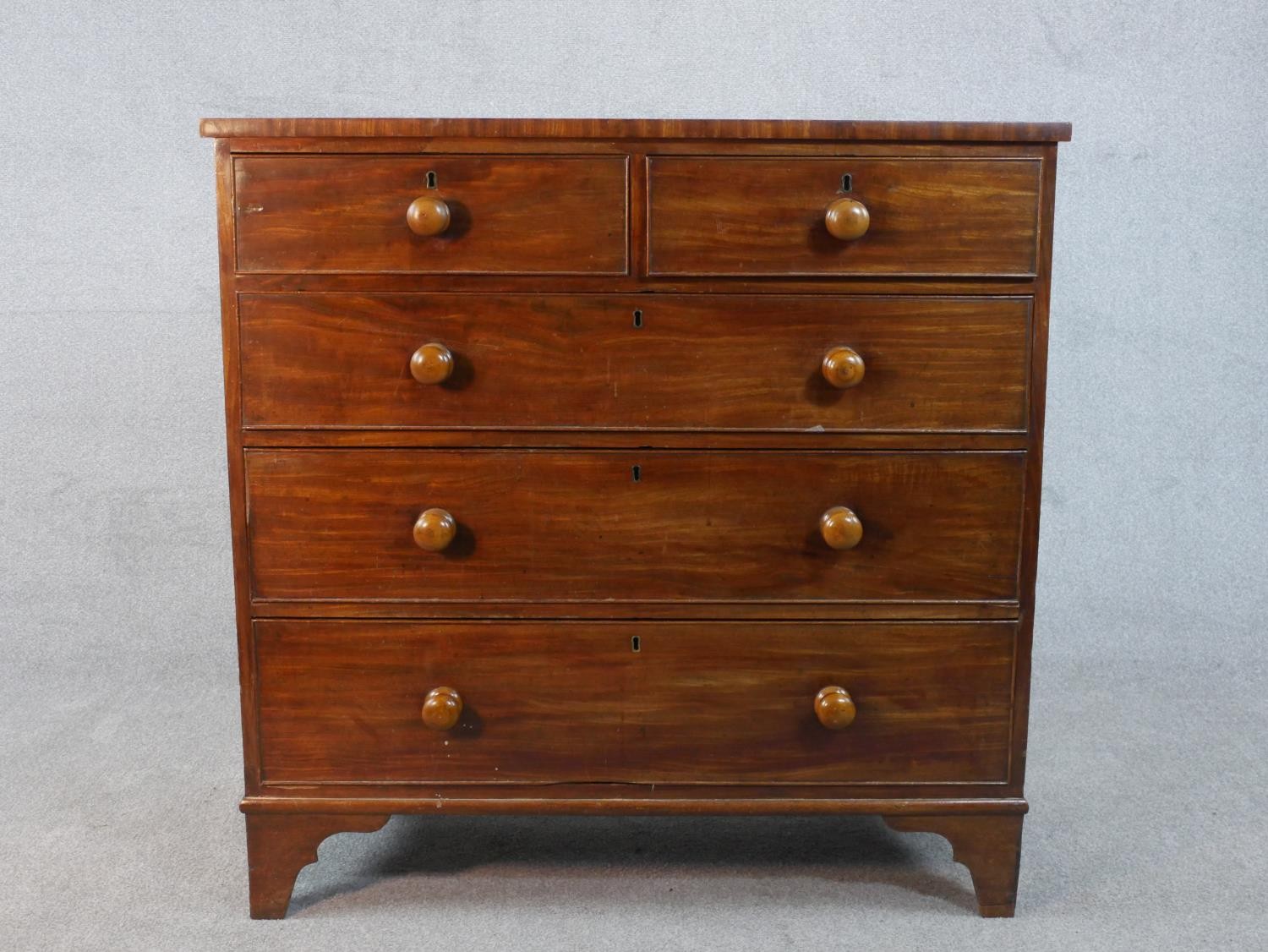A Georgian mahogany chest of drawers on shaped bracket feet. H.106 W.107 D.48cm