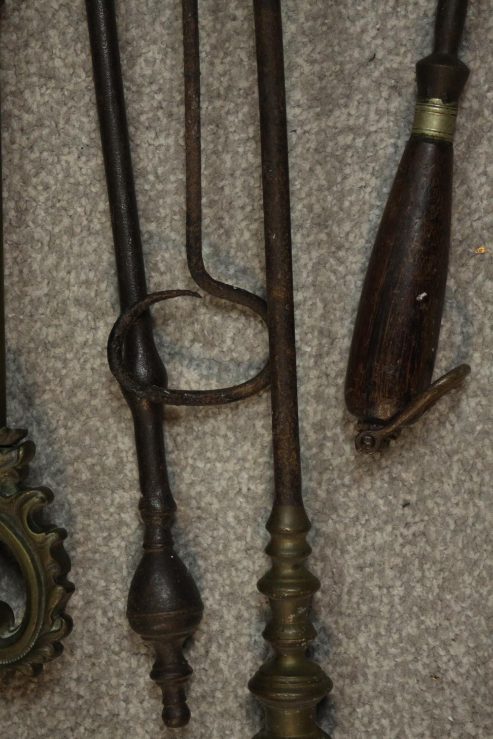 A collection of early 20th century cast iron and brass fire irons, other tools and a cast iron three - Image 6 of 7