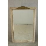 A rectangular wall mirror, in a grey painted and distressed frame with a white painted slip, with