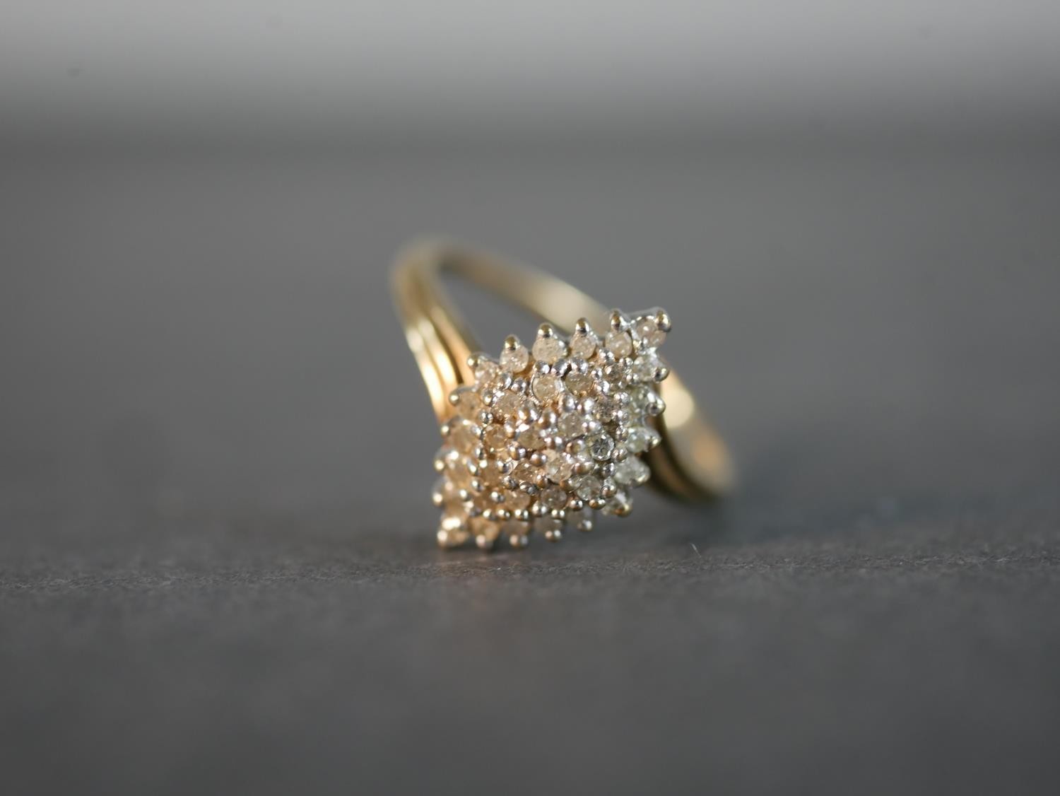 A 9 carat yellow gold and diamond cluster ring, set with thirty four round eight cut diamonds with a