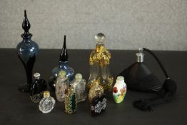 A collection of perfume bottles, including two reverse painted Chinese snuff bottles decorated