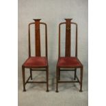 A pair of marquetry inlaid Arts & Crafts oak high back side chairs, the back inlaid with an Egyptian