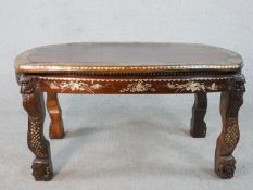 An early 20th century Chinese hardwood table with carved figural legs, all over inlaid with a mother