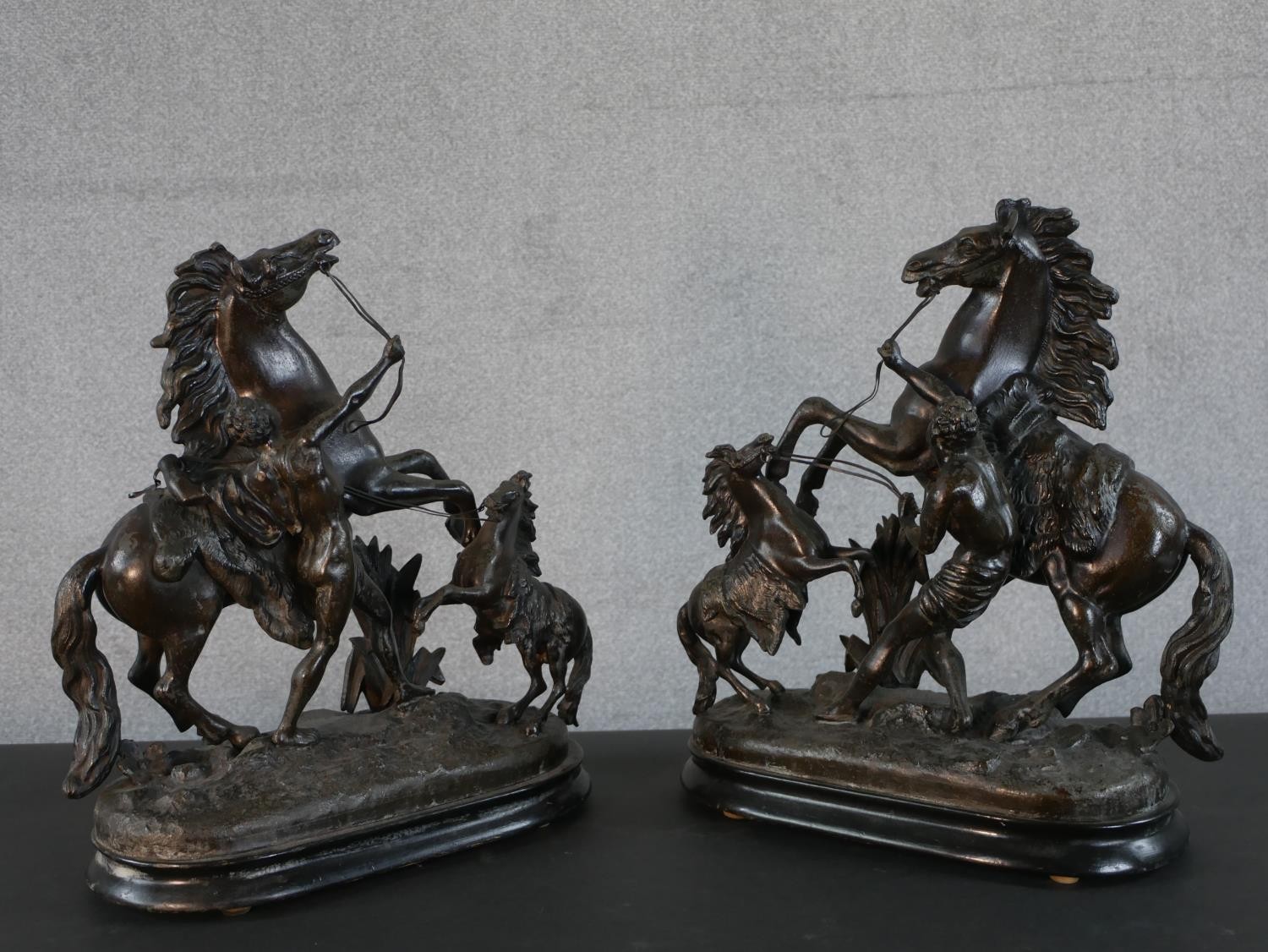 A pair of early 20th century spelter Marly horse figure groups with foals on ebonised bases. H.41