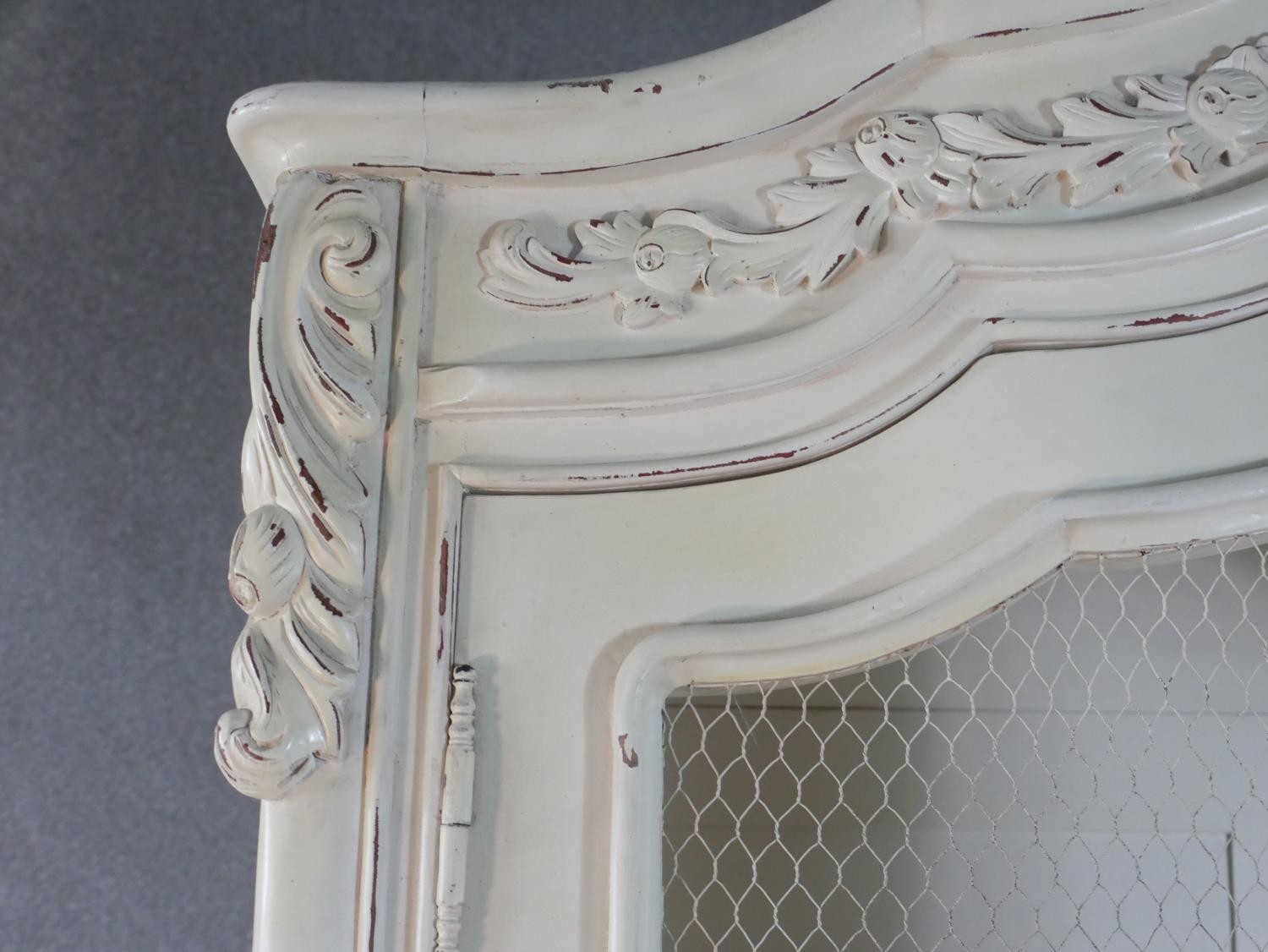 A French white painted and distressed bibliotheque, the carved cornice over two doors with mesh - Image 4 of 7