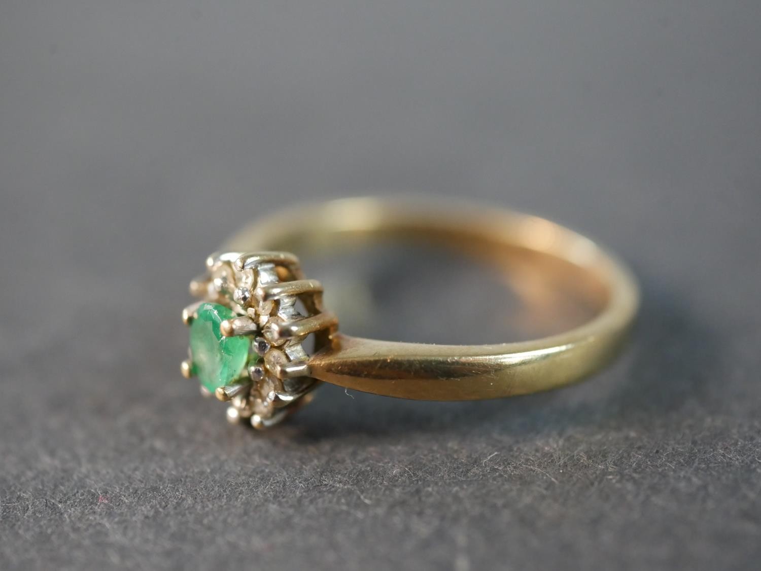 A 9 carat gold vintage emerald and diamond cluster ring, set to the centre with an oval mixed cut - Image 2 of 6