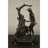 A Leonardo Collection bronze resin figure group of a young couple with a wheelbarrow under a tree.
