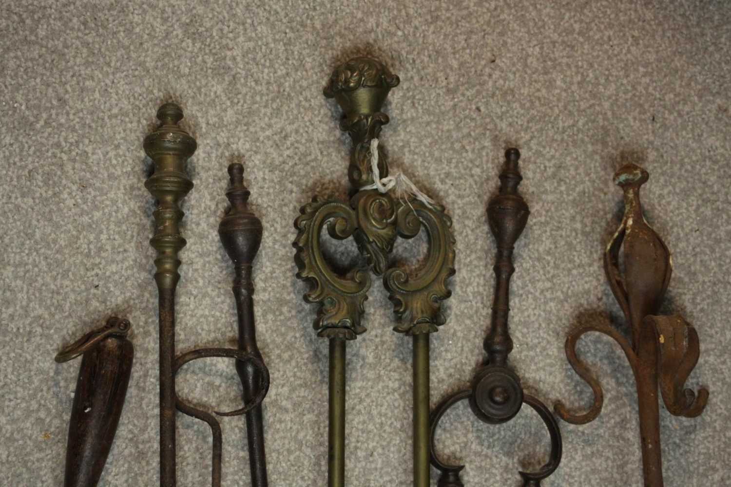 A collection of early 20th century cast iron and brass fire irons, other tools and a cast iron three - Image 3 of 7