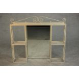 A cream painted wrought iron vanity shelf, the central rectangular mirror surrounded by an