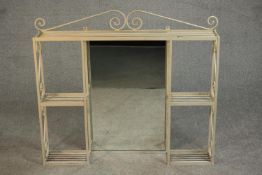 A cream painted wrought iron vanity shelf, the central rectangular mirror surrounded by an