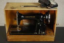 A cased Chapman eletrical sewing machine. H.23 W.35 D.50cm.