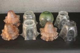 A collection of twelve Victorian etched glass lamp shades, including a set of six peach glass ripple