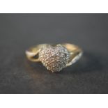 A 10 carat yellow gold and diamond heart ring, set with thirty two round eight cut diamonds with a