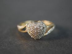 A 10 carat yellow gold and diamond heart ring, set with thirty two round eight cut diamonds with a